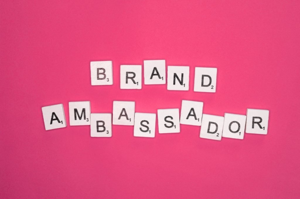 Brand ambassador scrabble letters word on a pink background